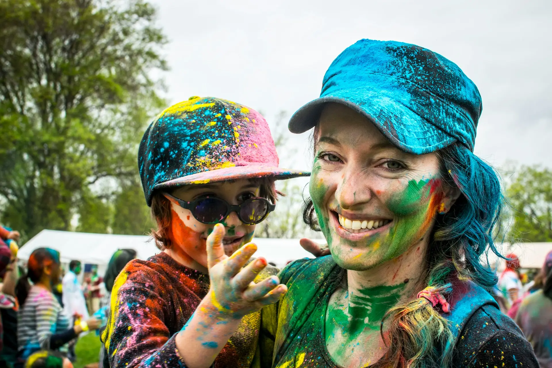 woman and child covered in celebration paint colours